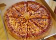 Pizza partida en porciones