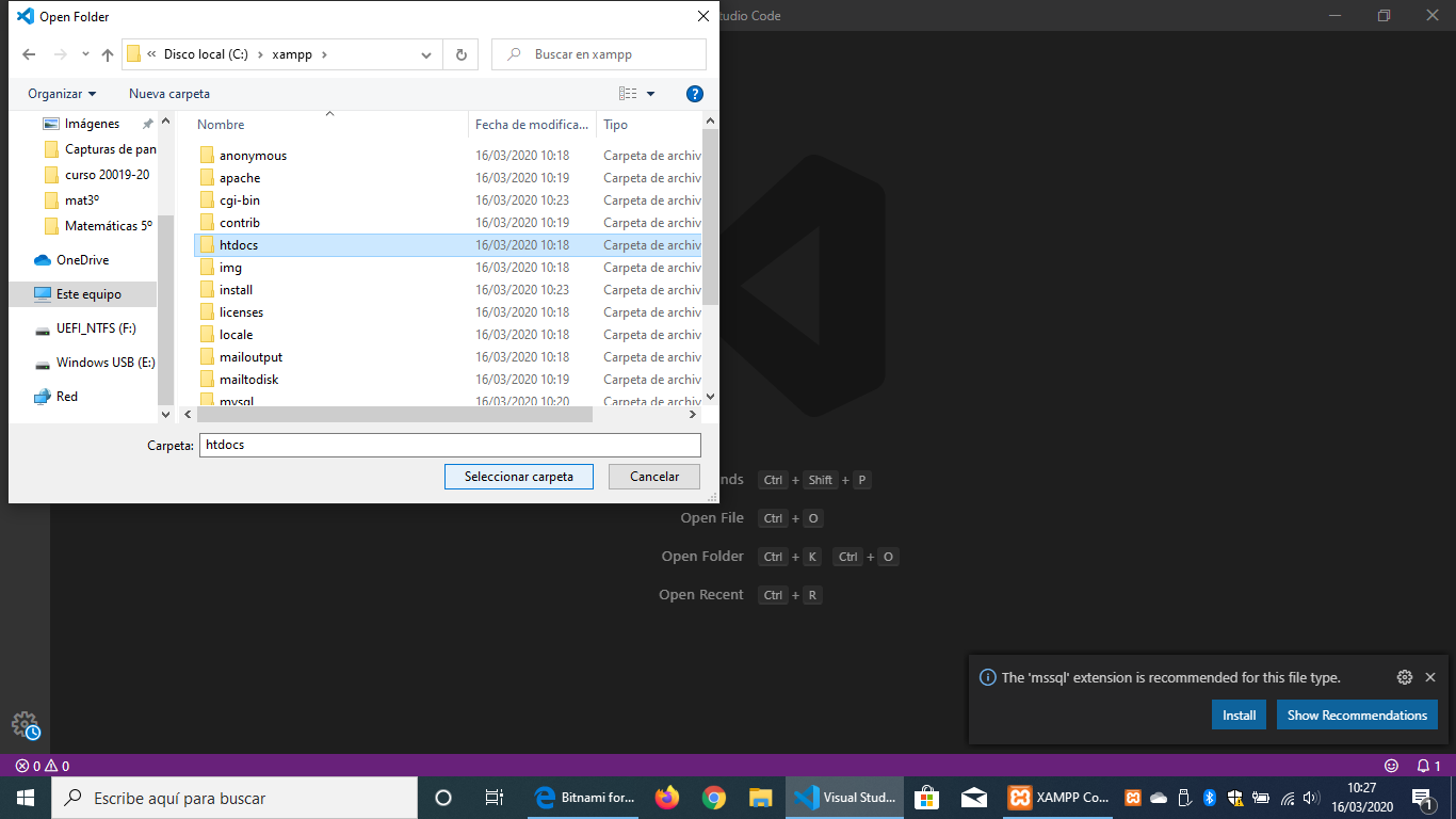 Imagen donde se muestra el navegador de archivos de windows con la carpeta htdcos seleccionada, al fondo y con un tema oscuro el Visual Studio Code