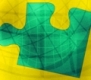 Pieza de puzzle verde con fondo amarillo.