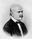  Retrato dibujado en blanco y negro del médico Semmelweis. Es un señor calvo, con bigote y que viste traje de chaqueta con palomita negra.