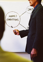 A man in front of a blackboard.