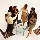 Conjunto de seis personas vistas del arriba, se saludan en actitud de conformidad .Las personas están bien vestidas parecen ejecutivos. En el centro de la imagen hay una mesa de cristal. También se observan tres sillas.