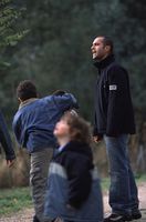 Fotografía en la que se ve a Carlos vigilando a los niños que están jugando en el parque.