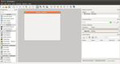 Imagen que muestra una captura de pantalla de la herramienta QT Designer con sus menús, y paneles a izquierda y derecha del lienzo, formado por un formulario en blanco preparado para ser diseñado.